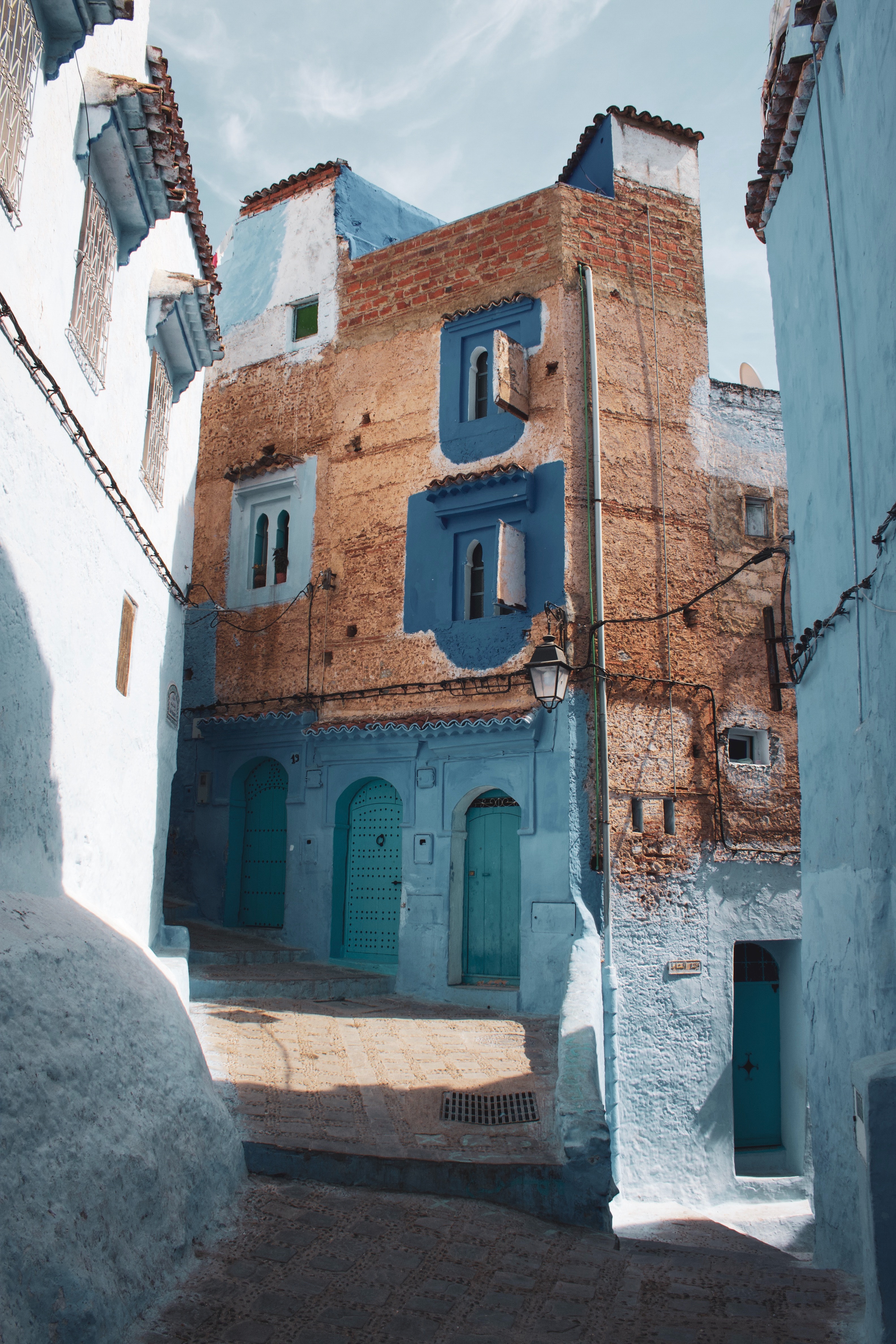 street with tall building with differnt colored blue doors